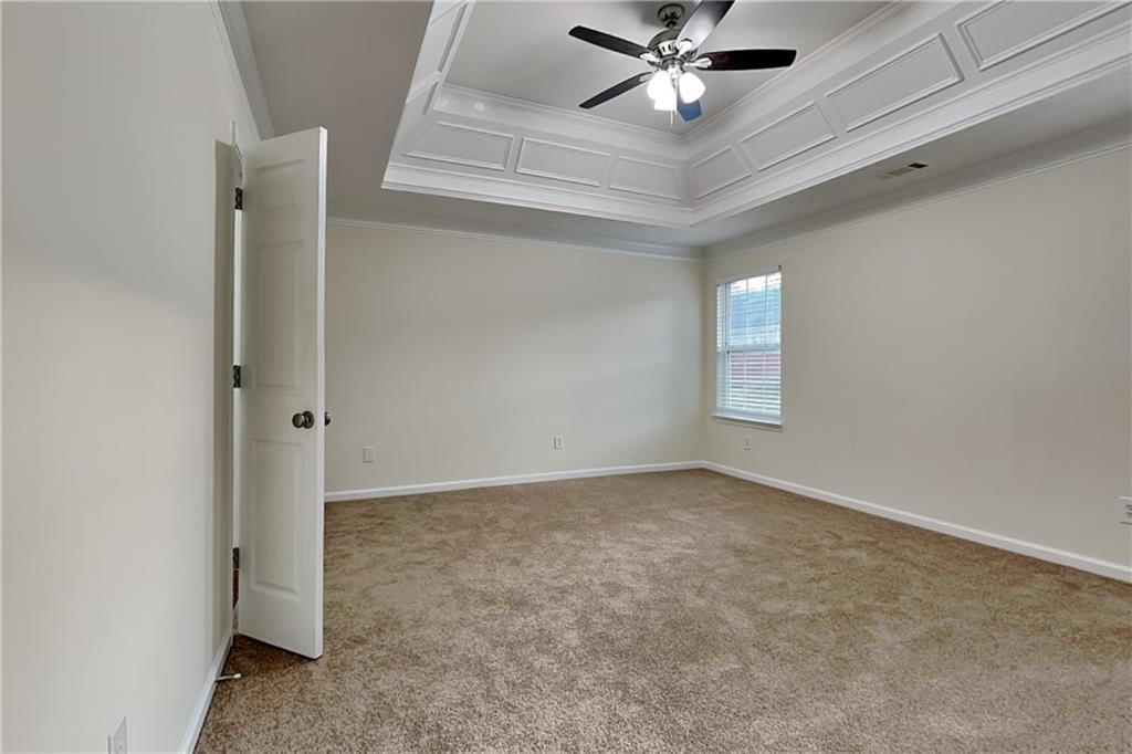 1595 Stephens Pond View Loganville, GA 30052 - Photo 9 of 22 an empty room with windows and fan