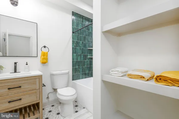a bathroom with a toilet a sink and a shower