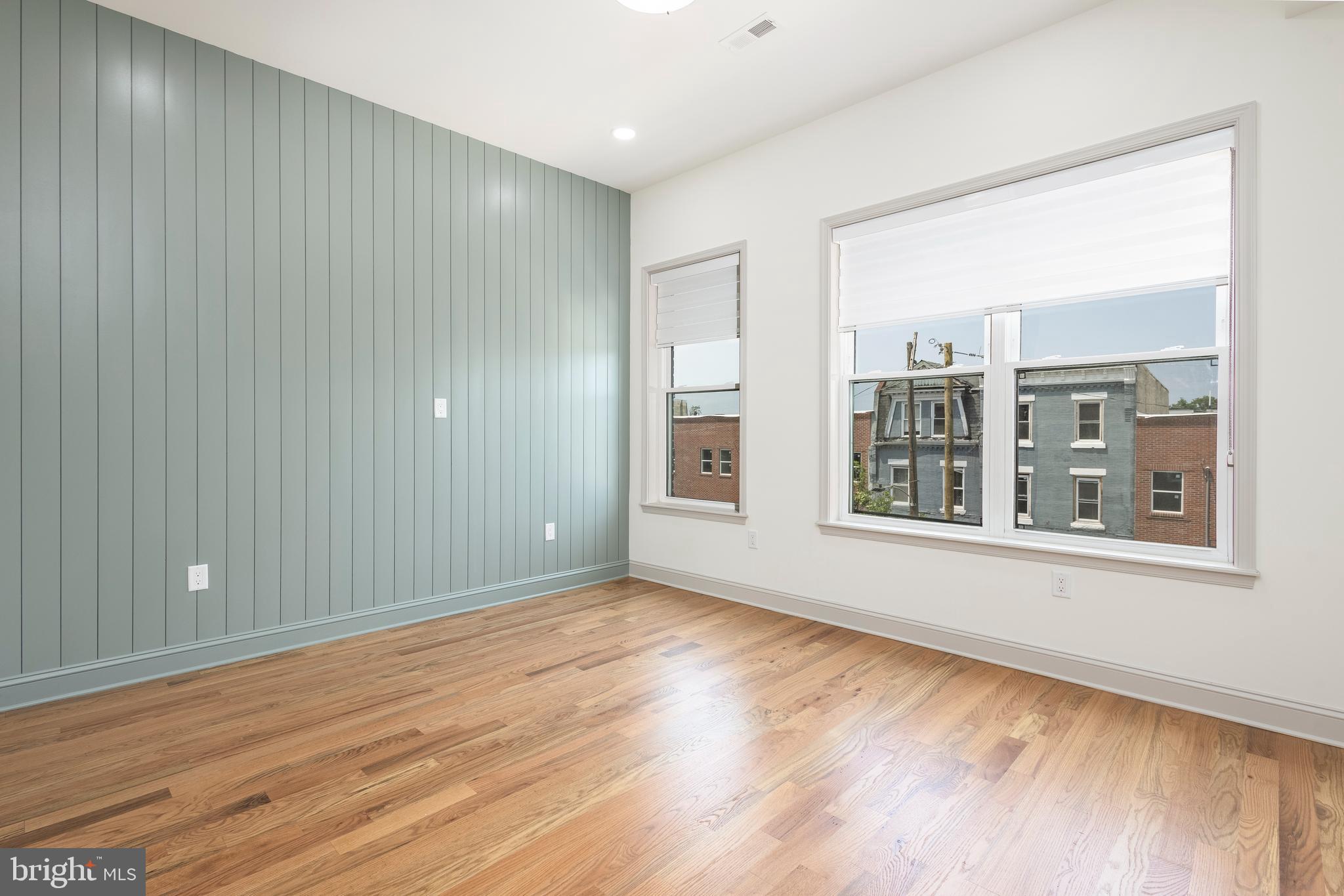 3116 Clifford Street, Unit B Philadelphia, PA 19121 - Photo 17 of 32 a view of an empty room with wooden floor and a window