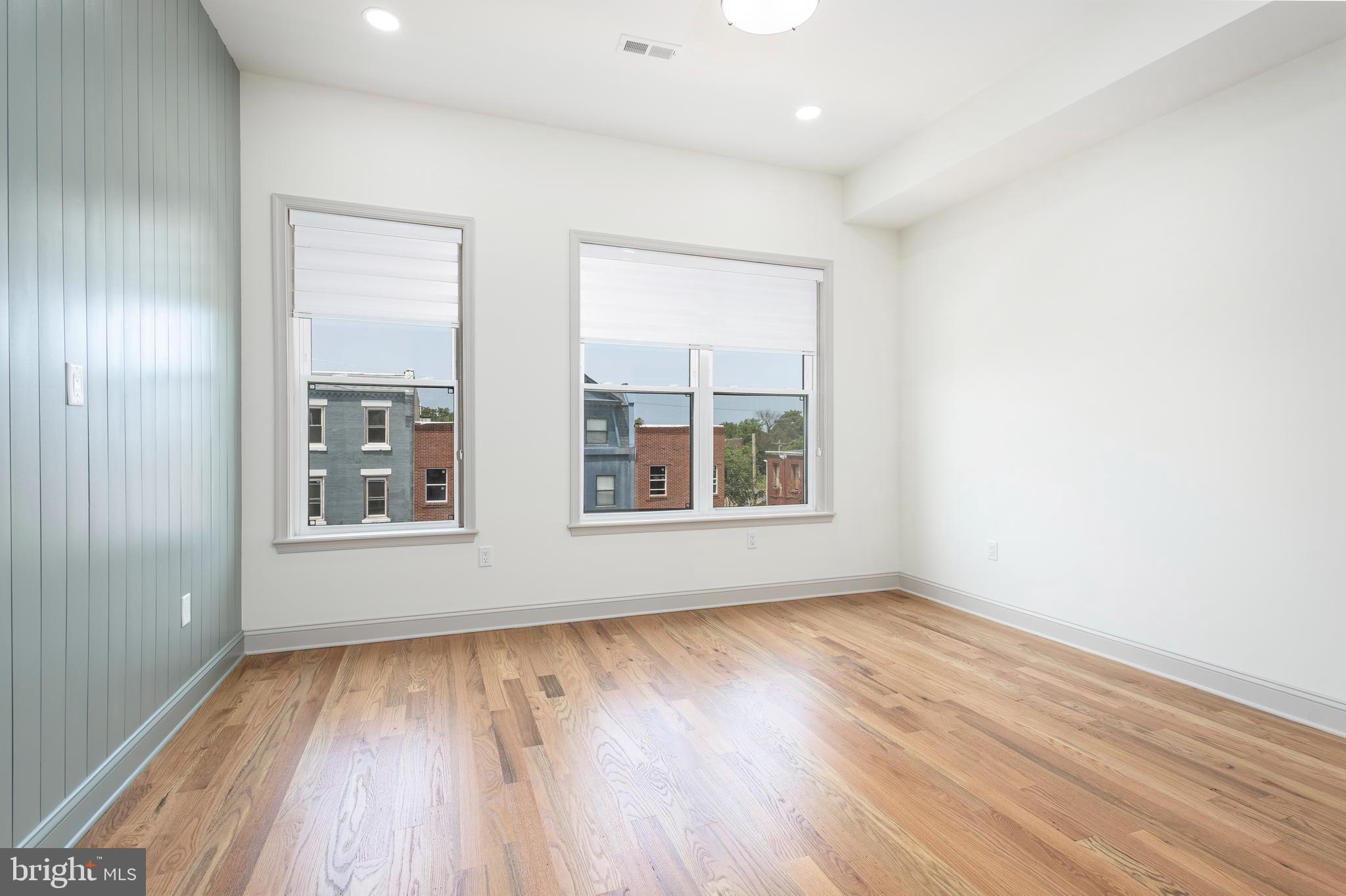 3116 Clifford Street, Unit B Philadelphia, PA 19121 - Photo 18 of 32 an empty room with wooden floor and windows