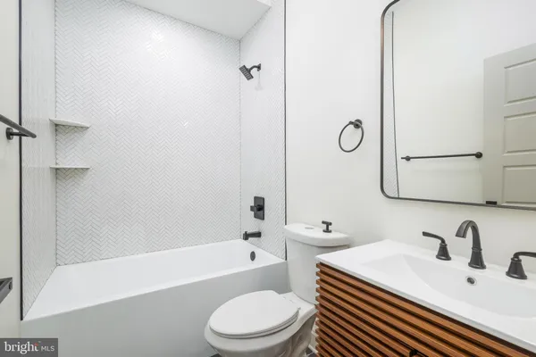 a bathroom with a toilet a sink and a bathtub