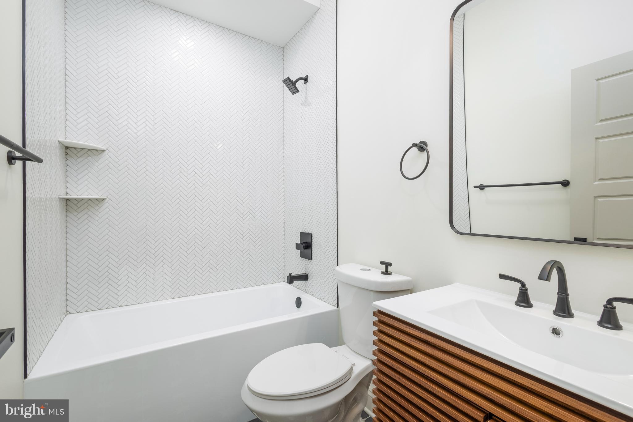 3116 Clifford Street, Unit B Philadelphia, PA 19121 - Photo 20 of 32 a bathroom with a toilet a sink and a bathtub