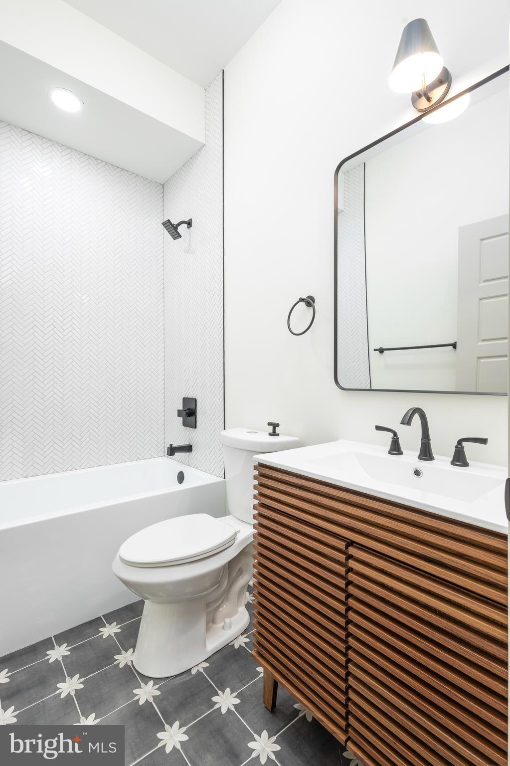 3116 Clifford Street, Unit B Philadelphia, PA 19121 - Photo 21 of 32 a bathroom with a sink toilet and mirror