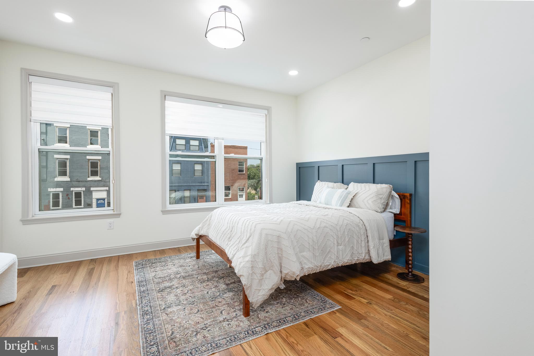 3116 Clifford Street, Unit B Philadelphia, PA 19121 - Photo 25 of 32 a bedroom with a bed and wooden floor