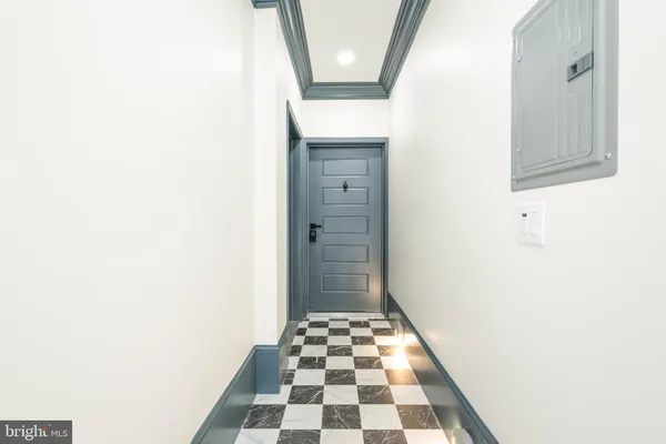 a bathroom with a black and white checkered floor