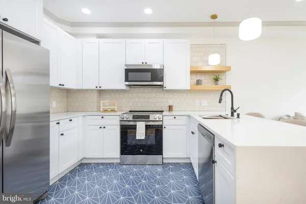 a kitchen with a sink stove and refrigerator
