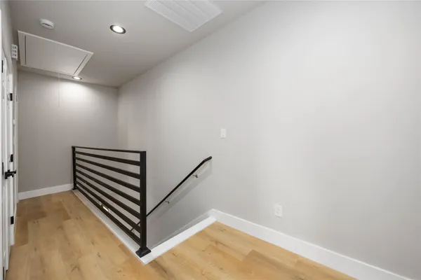a view of a room with wooden floor