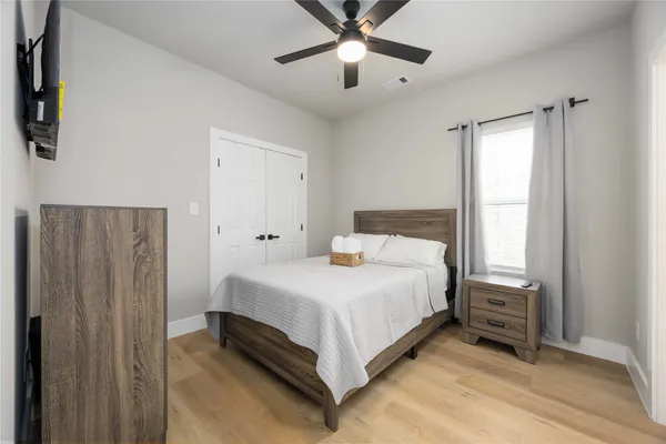 a bedroom with a bed and a television