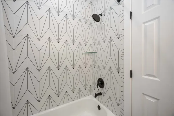 a bedroom with two beds and a chandelier