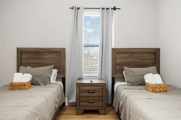 a bedroom with two beds and a flat screen tv