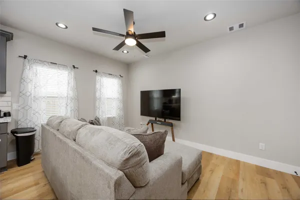 a living room with furniture and a walk in closet