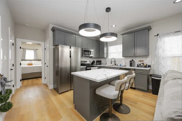 a kitchen with a sink stove and refrigerator