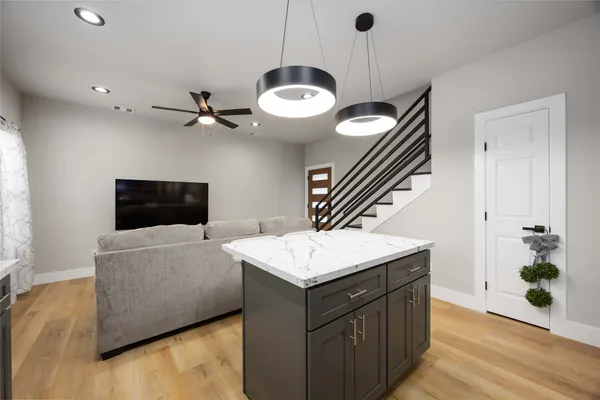 a kitchen with granite countertop cabinets a sink and a stove
