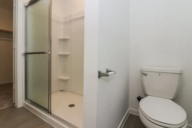 a white toilet sitting next to a bathroom sink