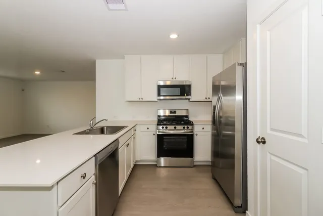 a kitchen with a sink stove and refrigerator