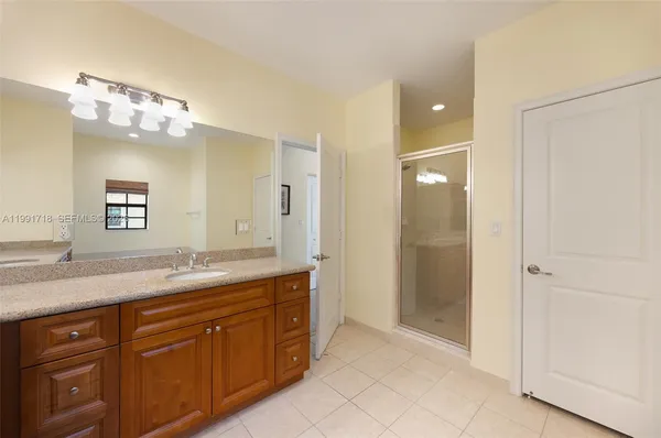 a bathroom with a granite countertop sink mirror and double
