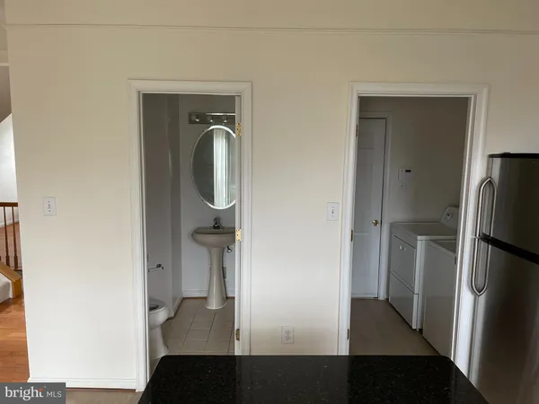 a view of walk in closet with wooden floor