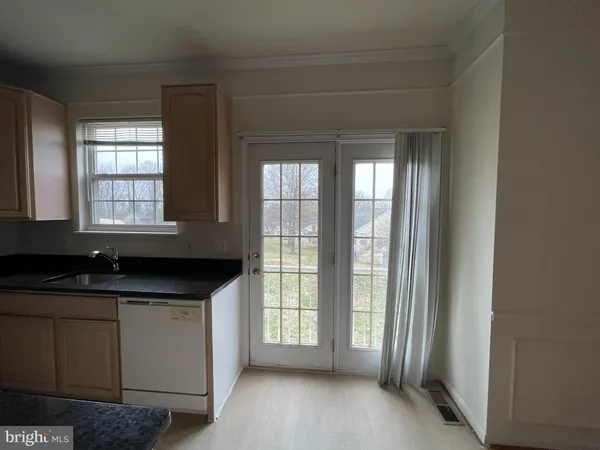 a kitchen with granite countertop a sink and a window