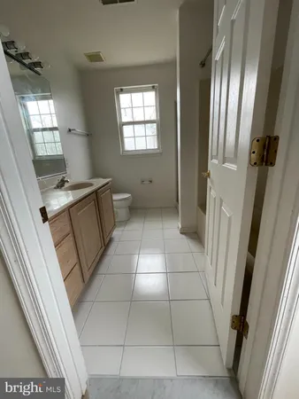 view of an empty room with wooden floor and a window