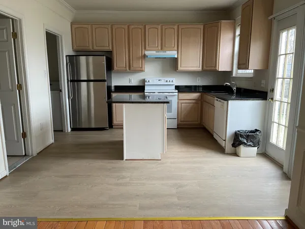a kitchen with a refrigerator and a sink