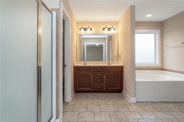 a bathroom with a bathtub sink and mirror