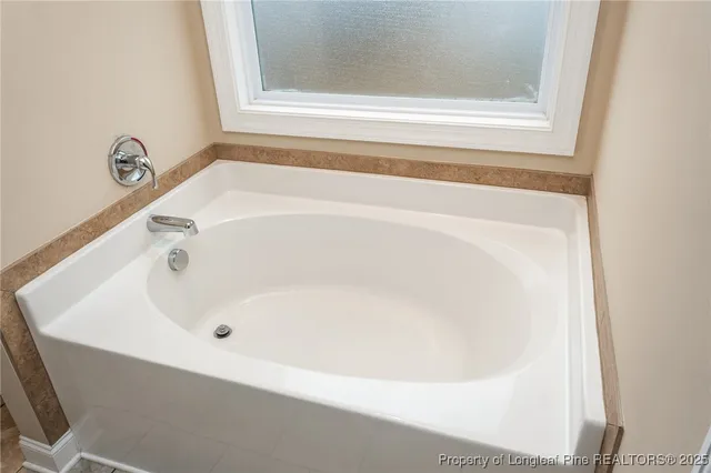 a white bath tub sitting next to a window