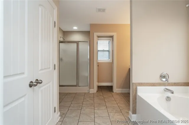 a bathroom with a tub a sink and mirror