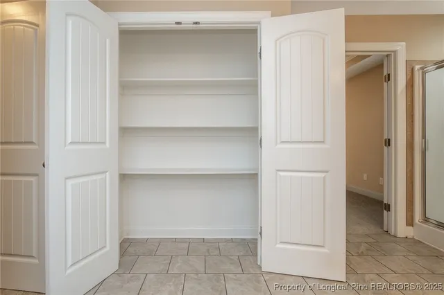 a view of a livingroom with a hall and wooden floor