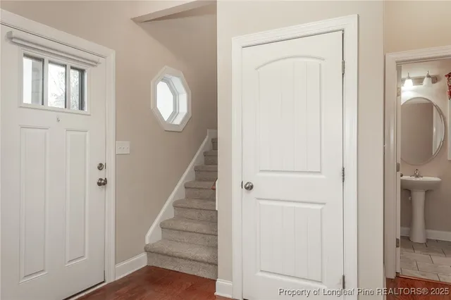a view of a hallway with wooden floor and entryway