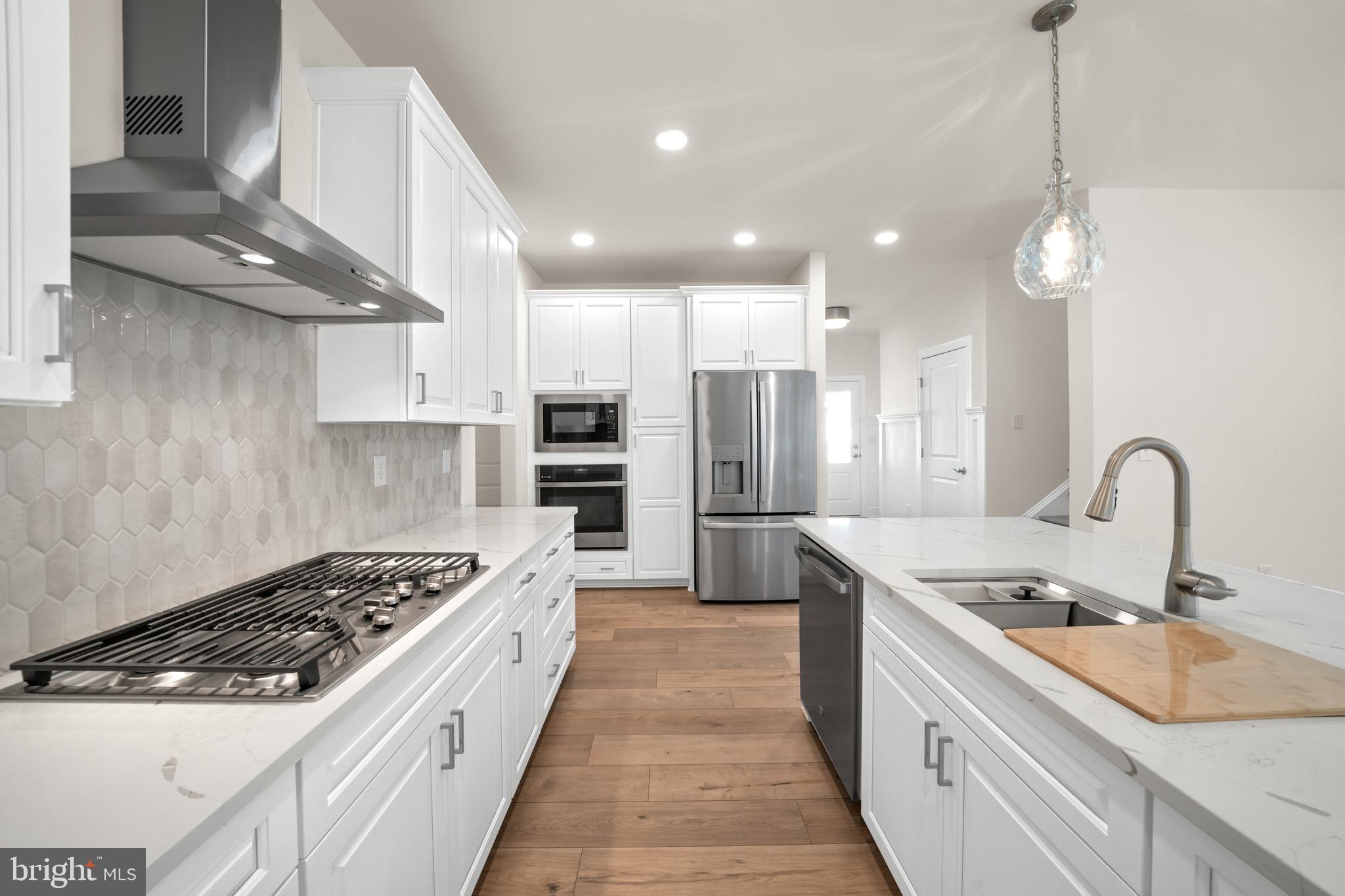 33766 Catching Cove Lewes, DE 19958 - Photo 14 of 47 a large kitchen with stainless steel appliances granite countertop a sink a stove and a refrigerator