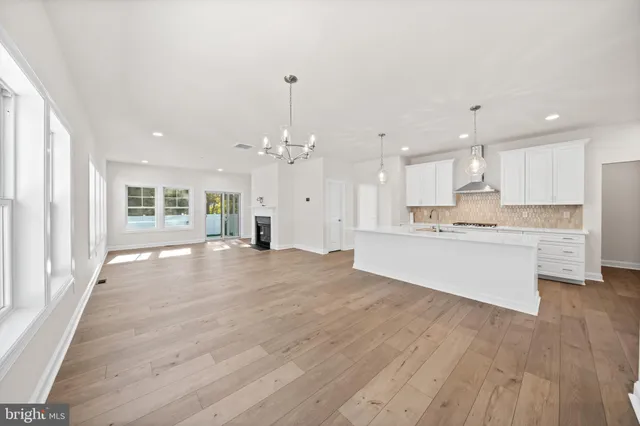 a big room with wooden floor and windows