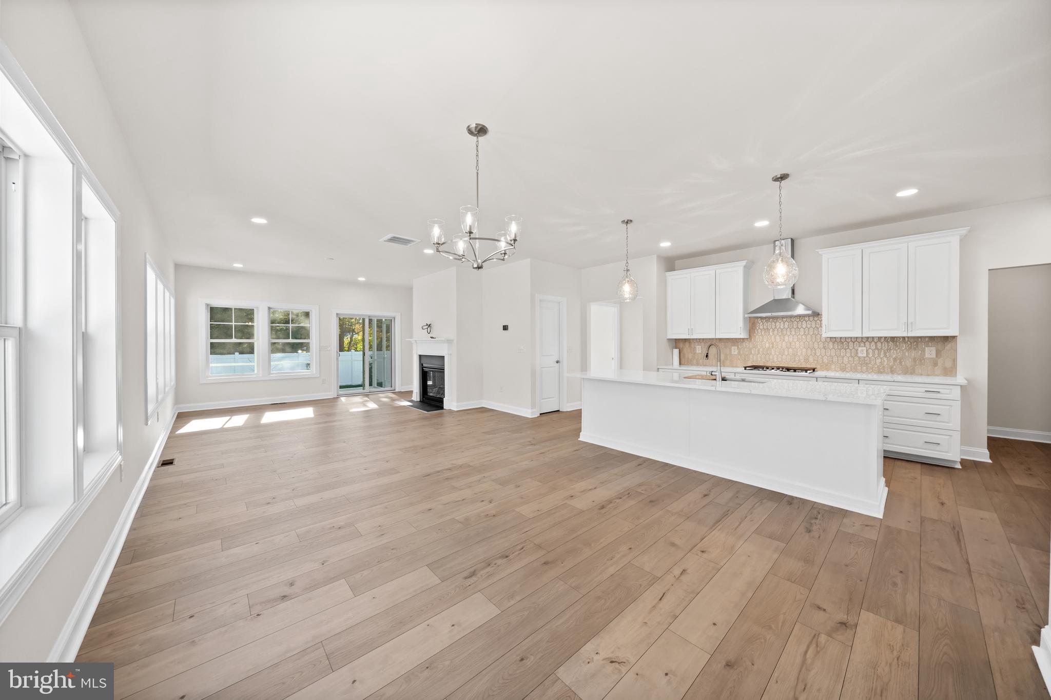 33766 Catching Cove Lewes, DE 19958 - Photo 16 of 47 a big room with wooden floor and windows