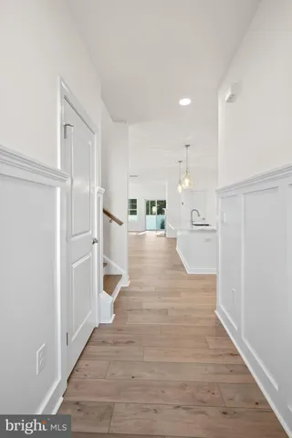 a view of a living room with furniture and wooden floor