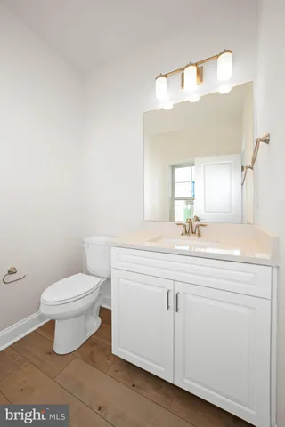 a bathroom with a toilet a sink and a mirror