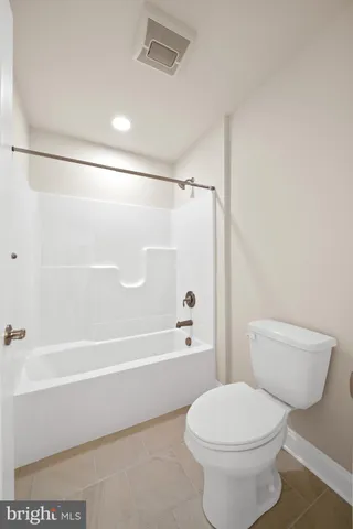 a bathroom with a toilet and a bathtub