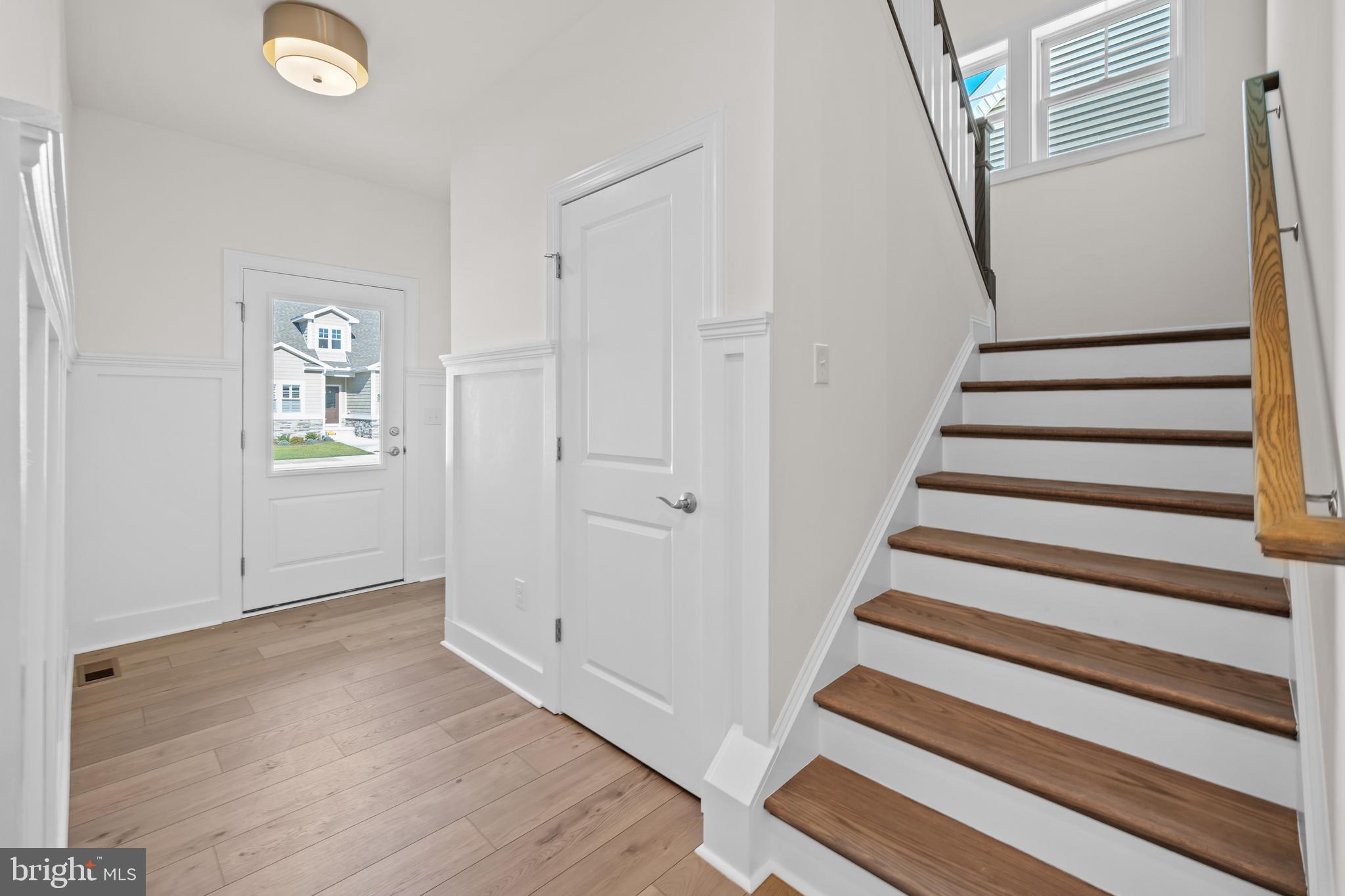 33766 Catching Cove Lewes, DE 19958 - Photo 31 of 47 a view of entryway with wooden floor and stairs