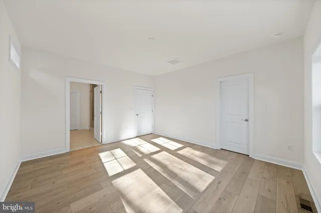 a view of an empty room and wooden floor