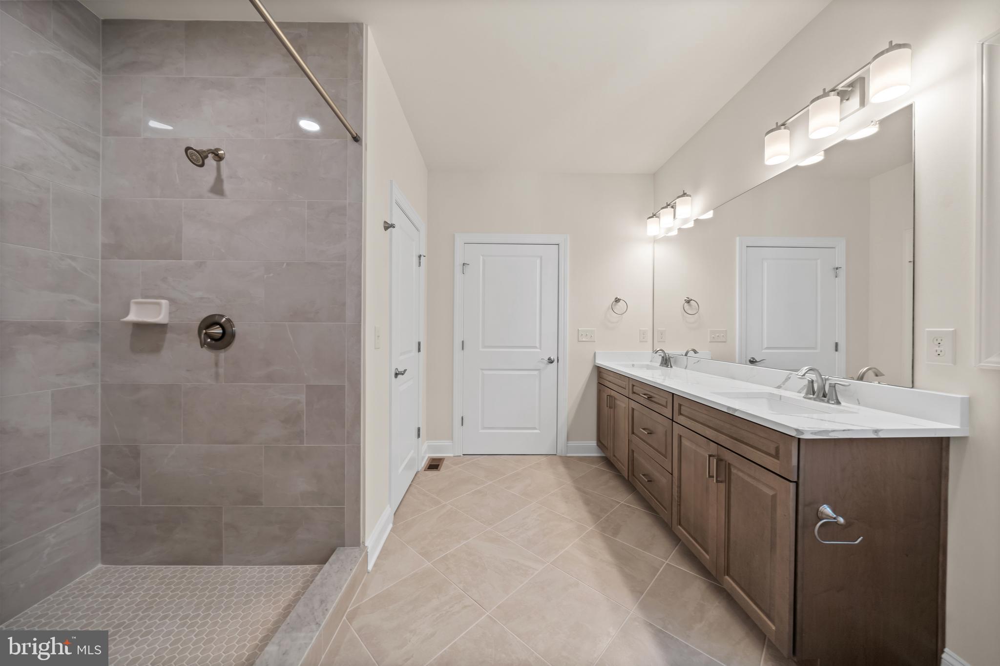 33766 Catching Cove Lewes, DE 19958 - Photo 40 of 47 a spacious bathroom with a double vanity sink mirror and shower
