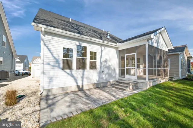 a view of house with backyard and glass door