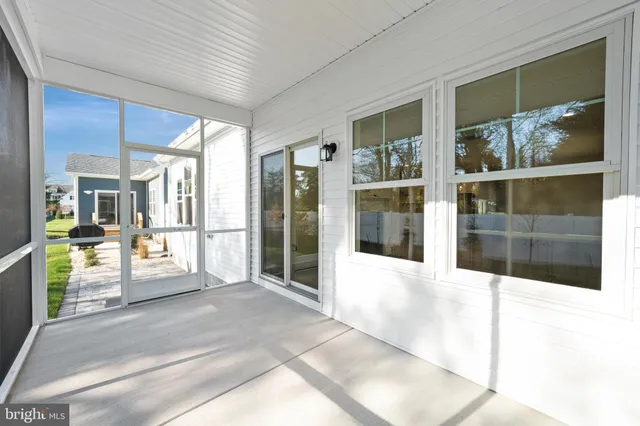 a view of a house with backyard porch and sitting area