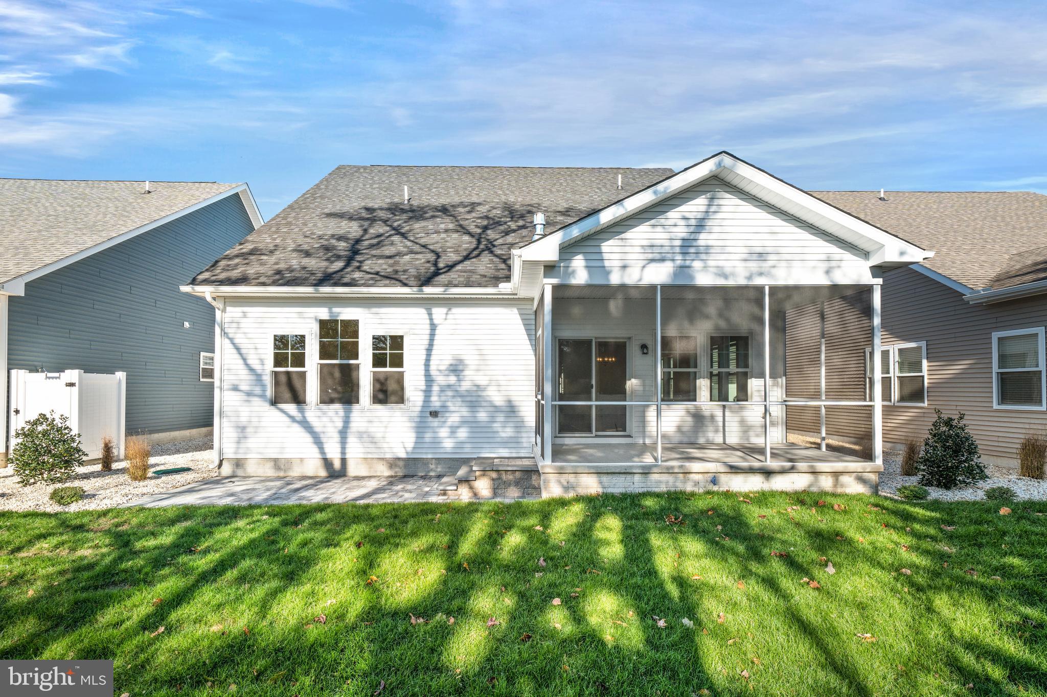 33766 Catching Cove Lewes, DE 19958 - Photo 45 of 47 a view of a house with backyard porch and sitting area