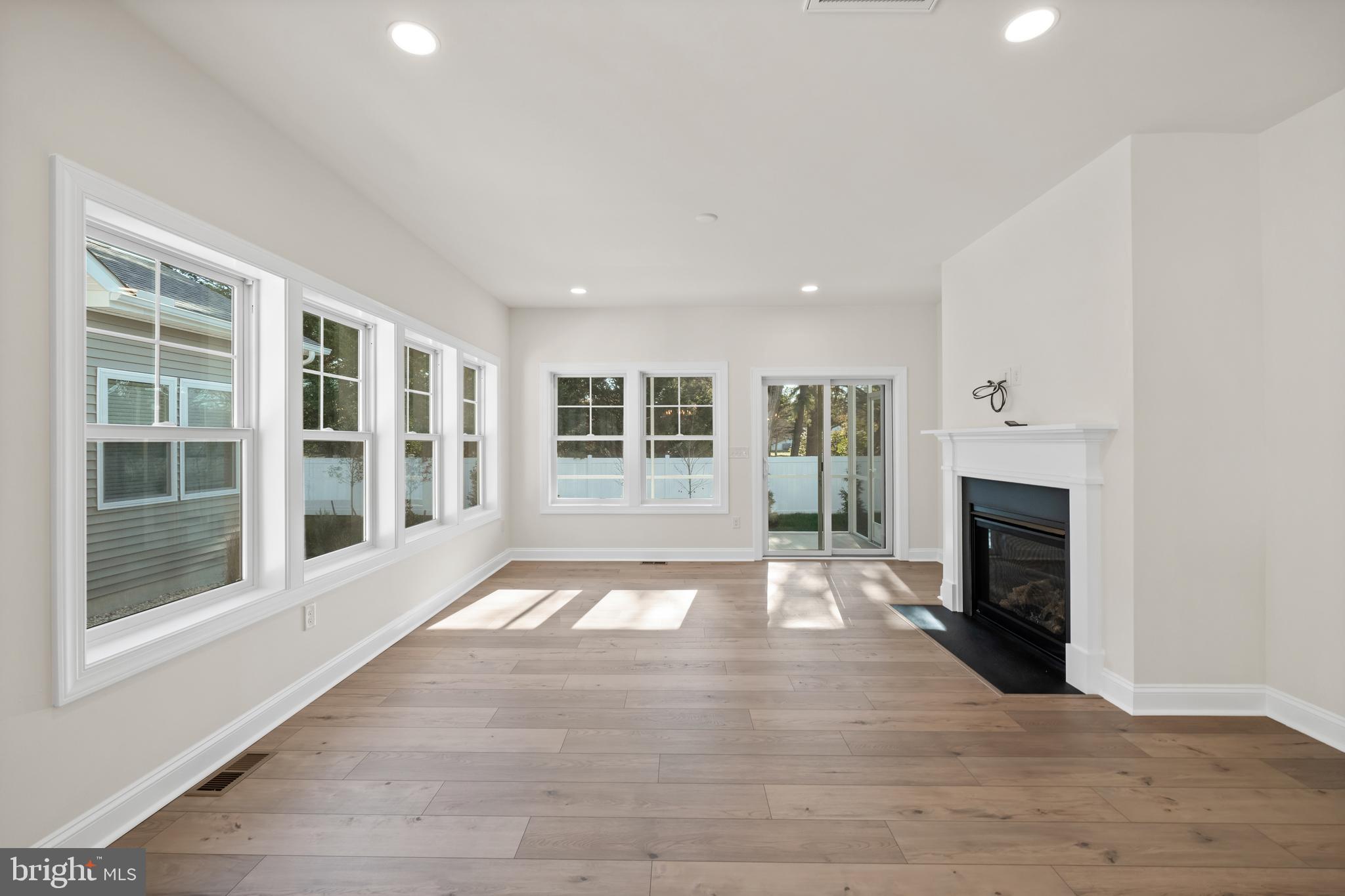 33766 Catching Cove Lewes, DE 19958 - Photo 7 of 47 a view of an empty room with wooden floor and a window