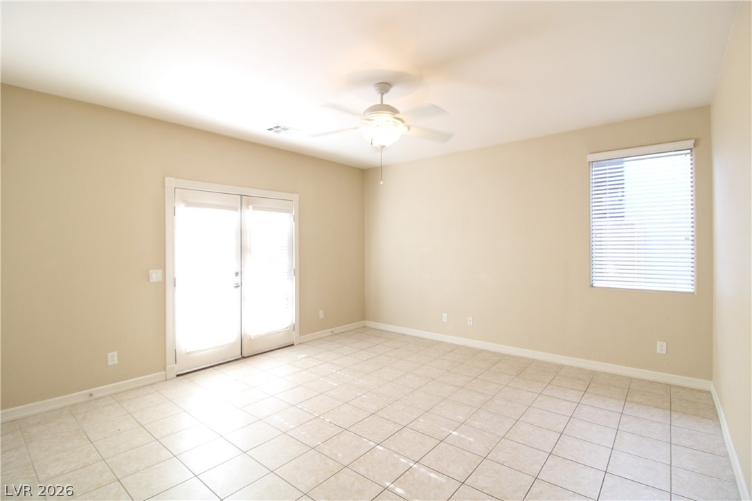 754 Rise Canyon Drive Henderson, NV 89052 - Photo 23 of 34 A spacious room offers direct access to the outdoors, complete with a practical ceiling fan.
