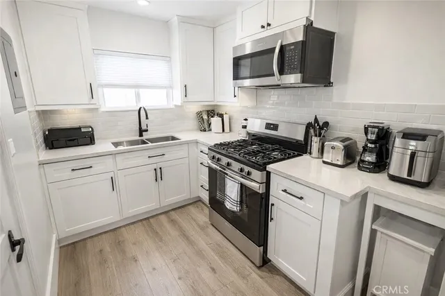a patio with a table and chairs under an umbrella