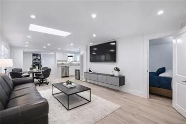 a bathroom with a sink a toilet a mirror and shower