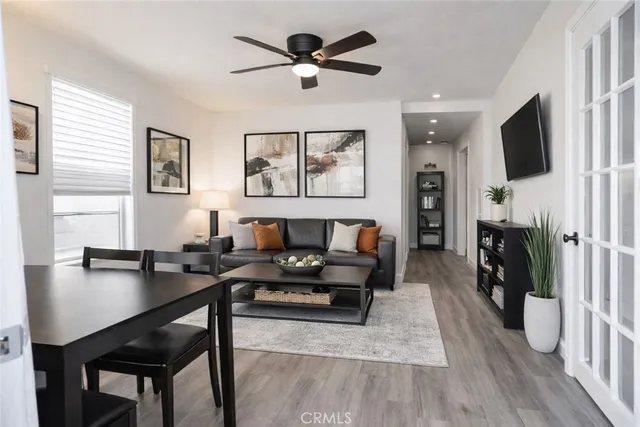 a living room with furniture and a wooden floor