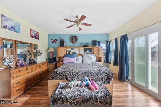 a bed room with a bed mirror and a window