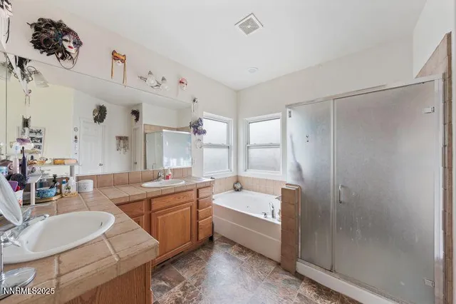 a bathroom with a double vanity sink mirror and bathtub