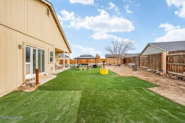 a view of a house with a yard and sitting area