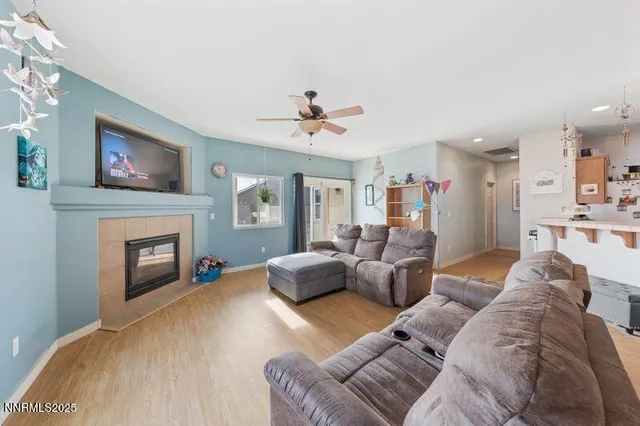 a living room with furniture a fireplace and a flat screen tv